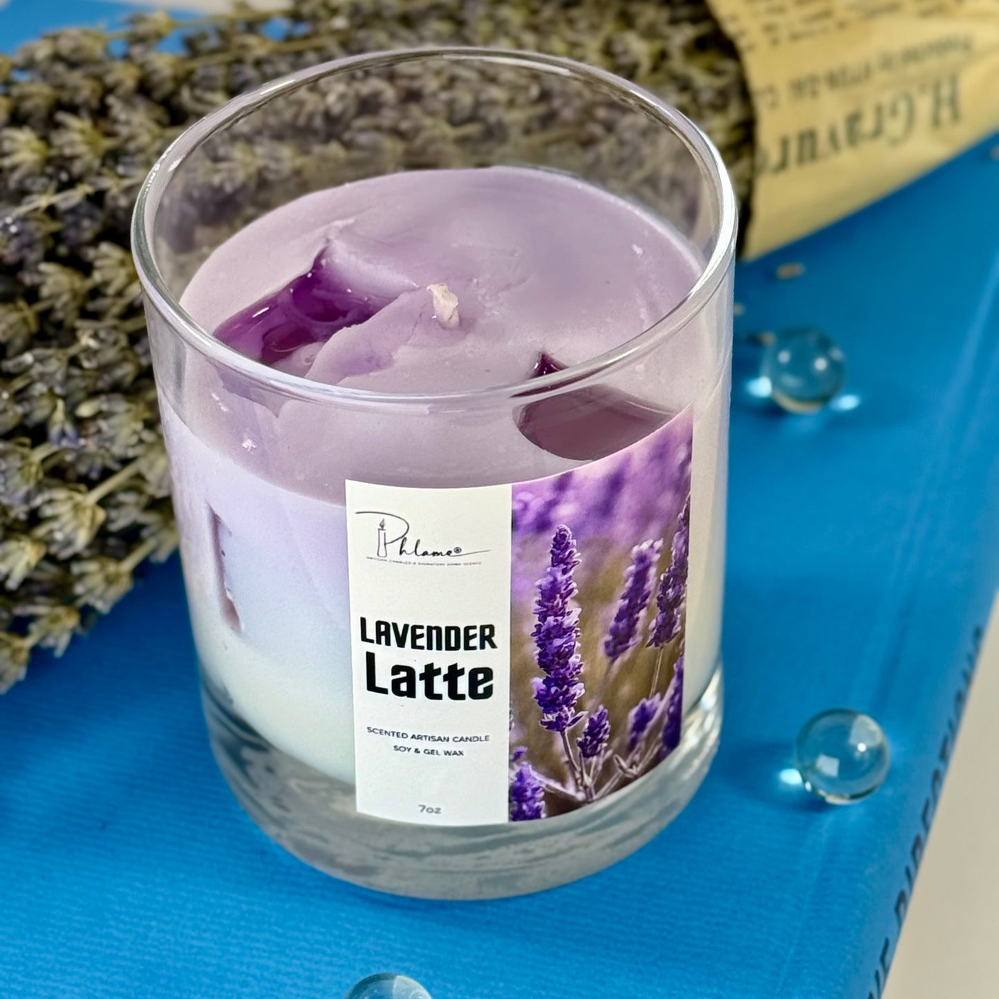 Lavender Latte candle in a glass container with lavender flowers in the background