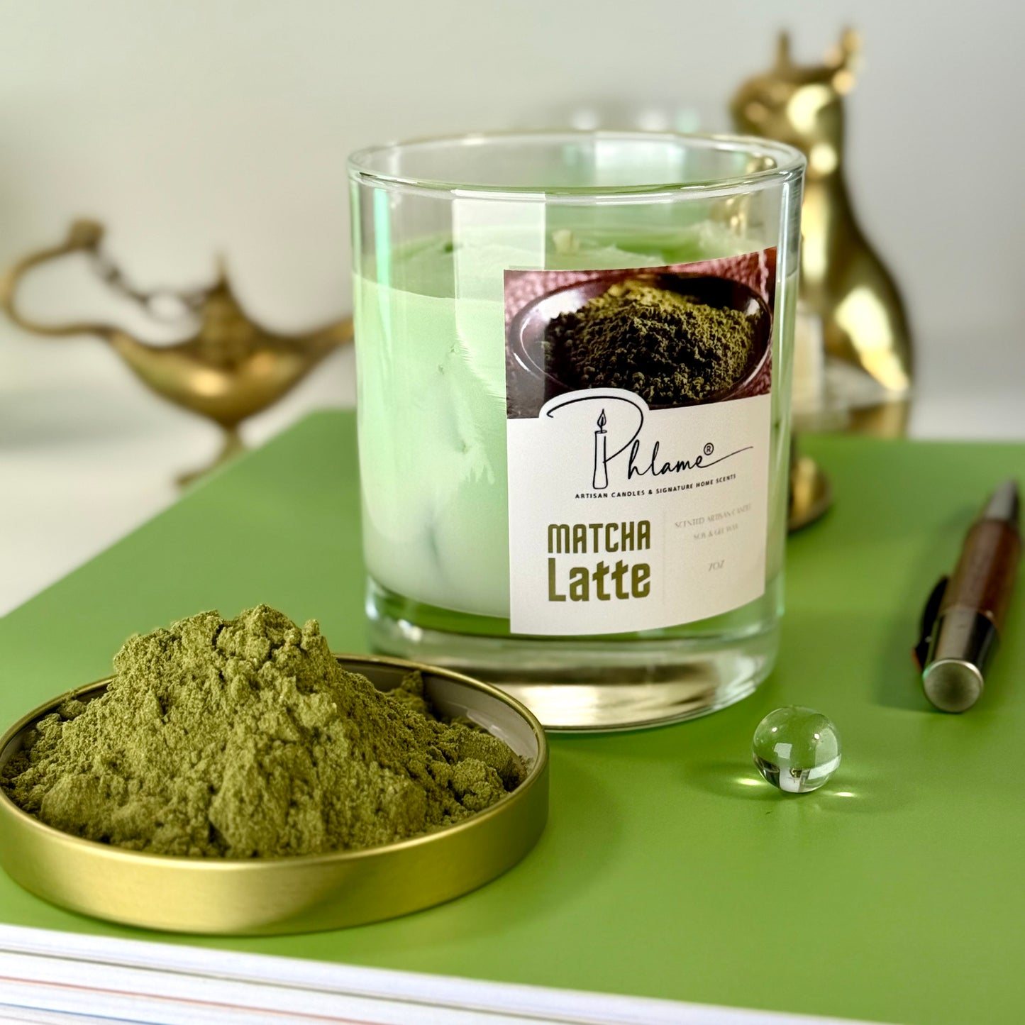 Matcha Latte candle with matcha powder on a green surface