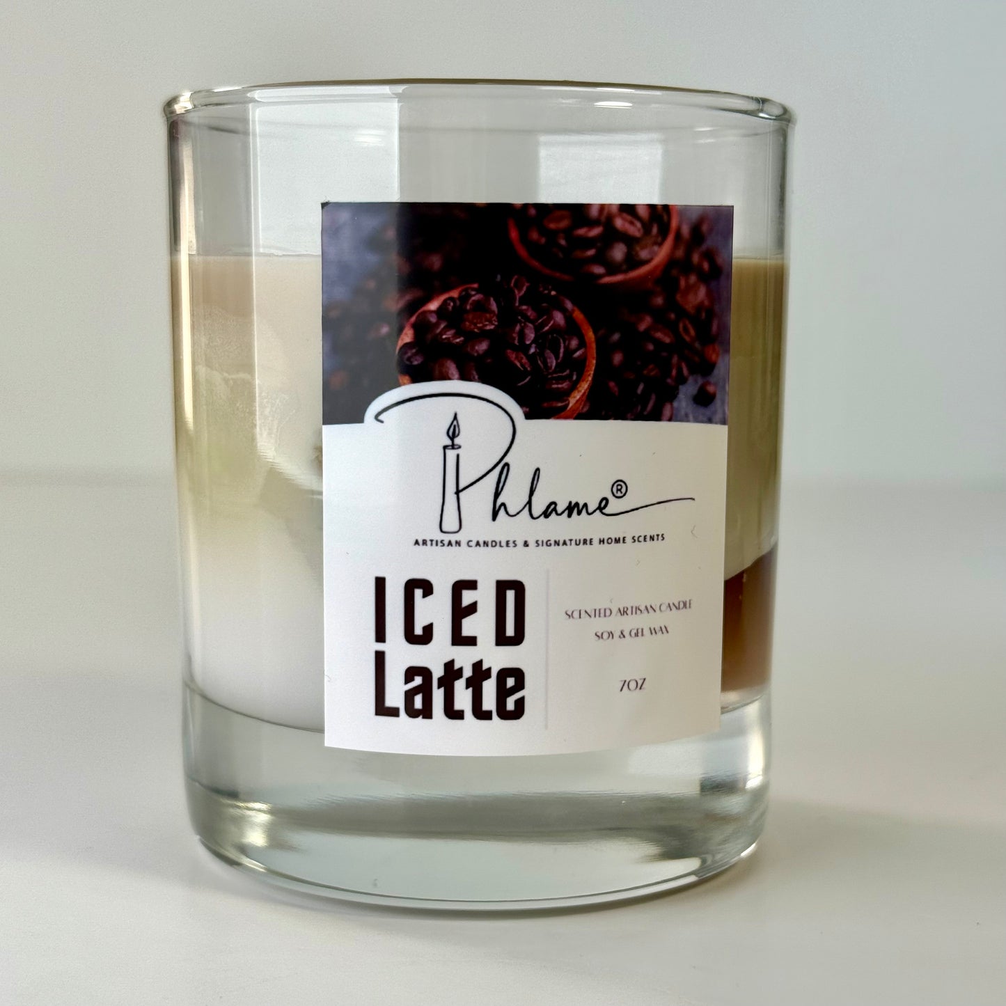 Candle in a glass jar labeled 'ICED Latte' by Phlame on a white background