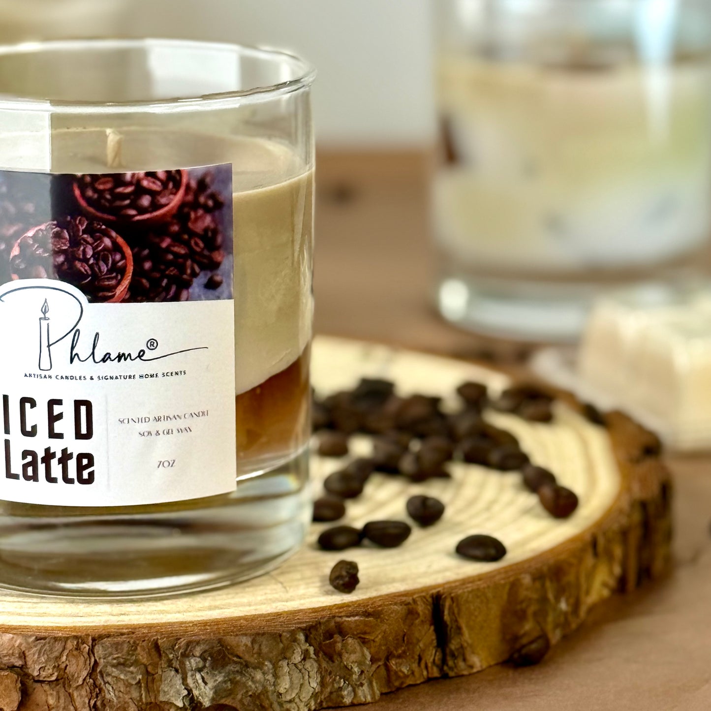 Phlame iced latte candle on a wooden coaster with coffee beans