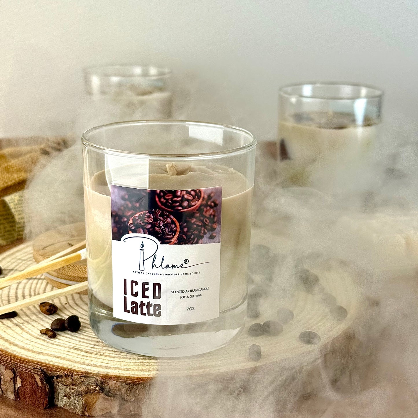 Candle labeled 'ICED Latte' with a label featuring coffee beans on a wooden surface.