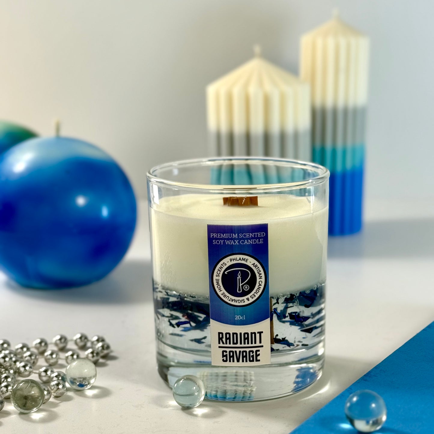 Radiant Savage candle with blue wax detail and black gift box, styled with cool-toned décor