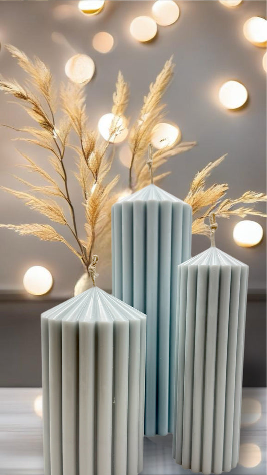 3 pillar candles are captured on the image. Hygge style