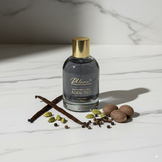 Addicted Vanille & Tabac Noir room and textile spray in black bottle with gold cap.