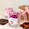 Glass candle labeled 'Rose Latte' with a decorative box in the background