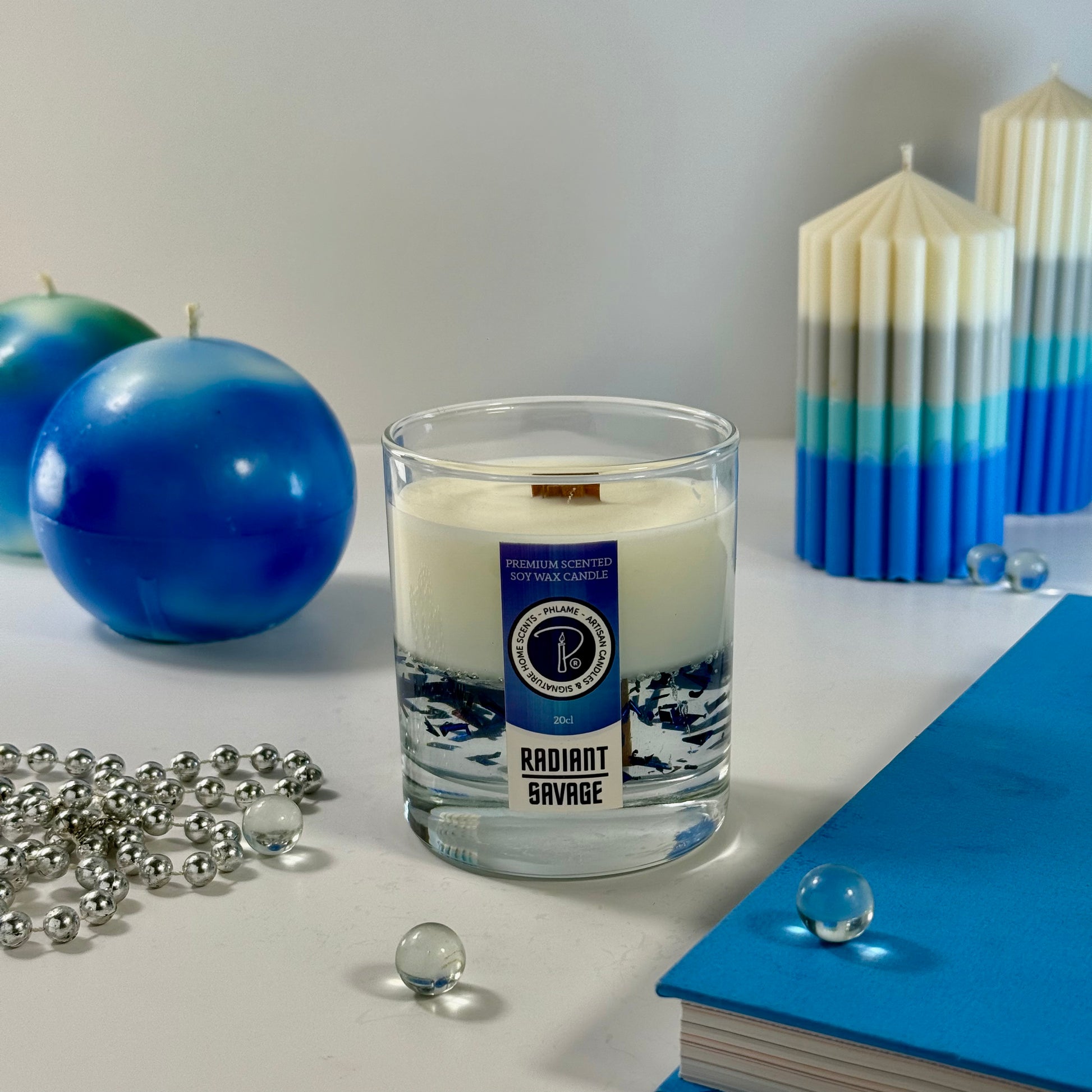 Radiant Savage candle with blue wax detail and black gift box, styled with cool-toned décor.