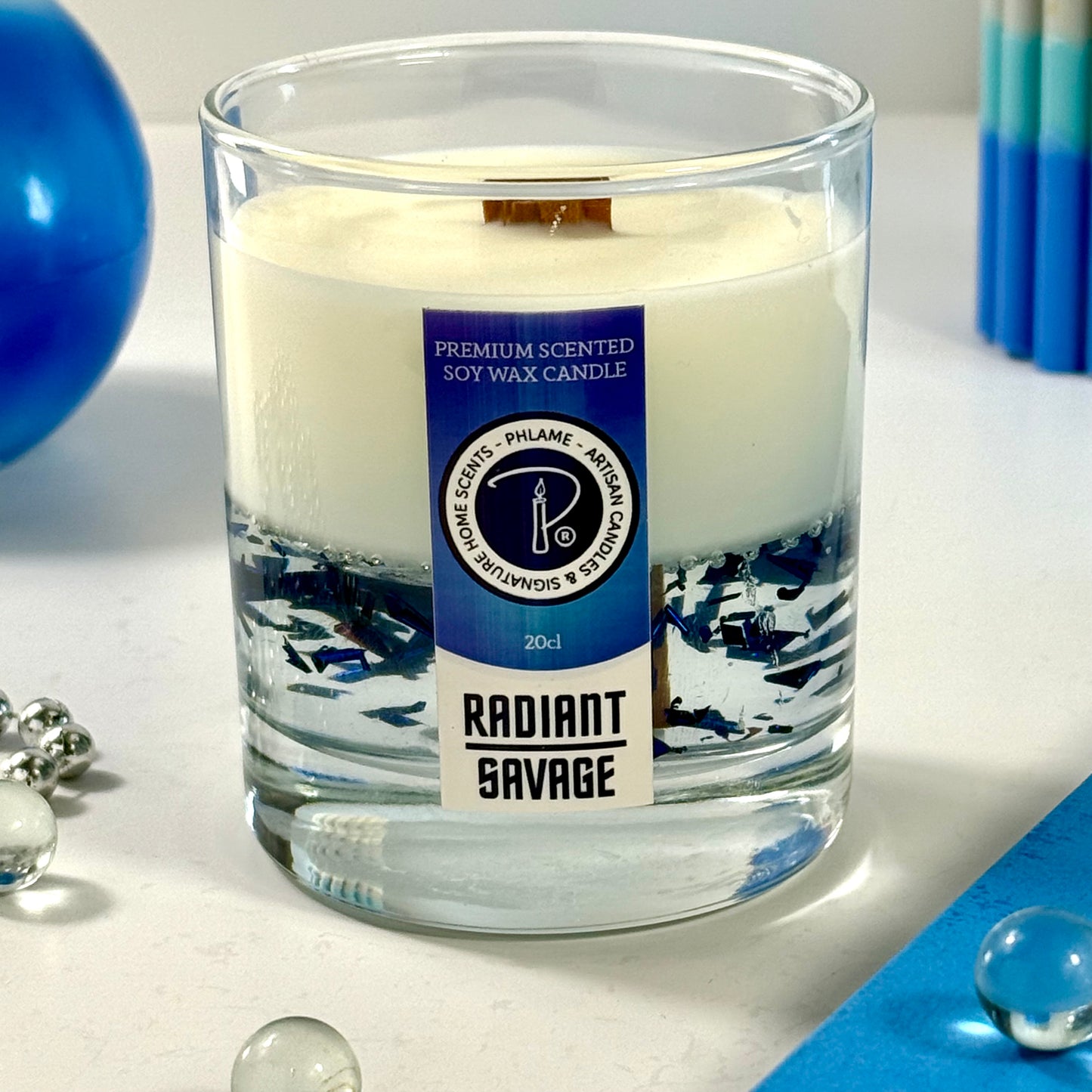 Radiant Savage candle with blue wax detail and black gift box, styled with cool-toned décor.