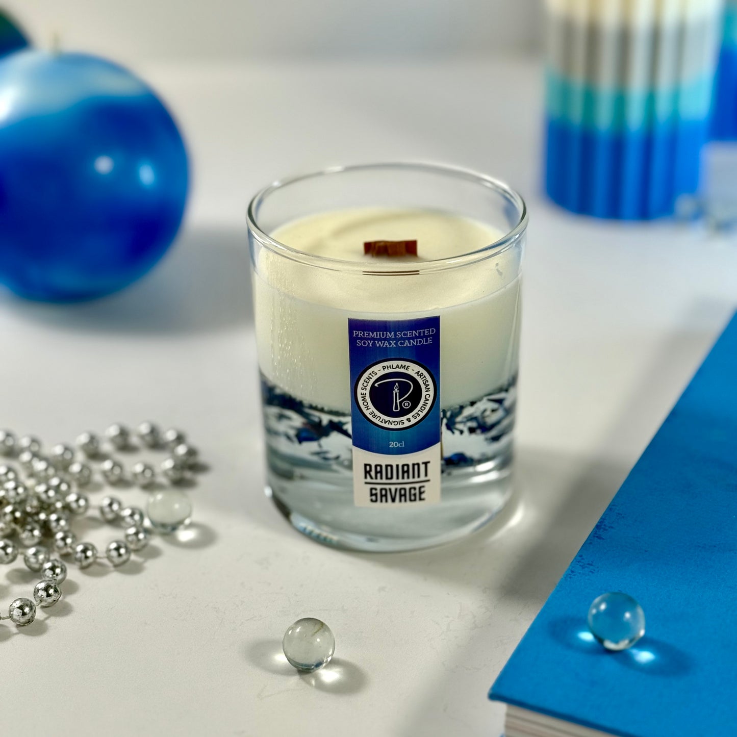 Radiant Savage candle with blue wax detail and black gift box, styled with cool-toned décor.