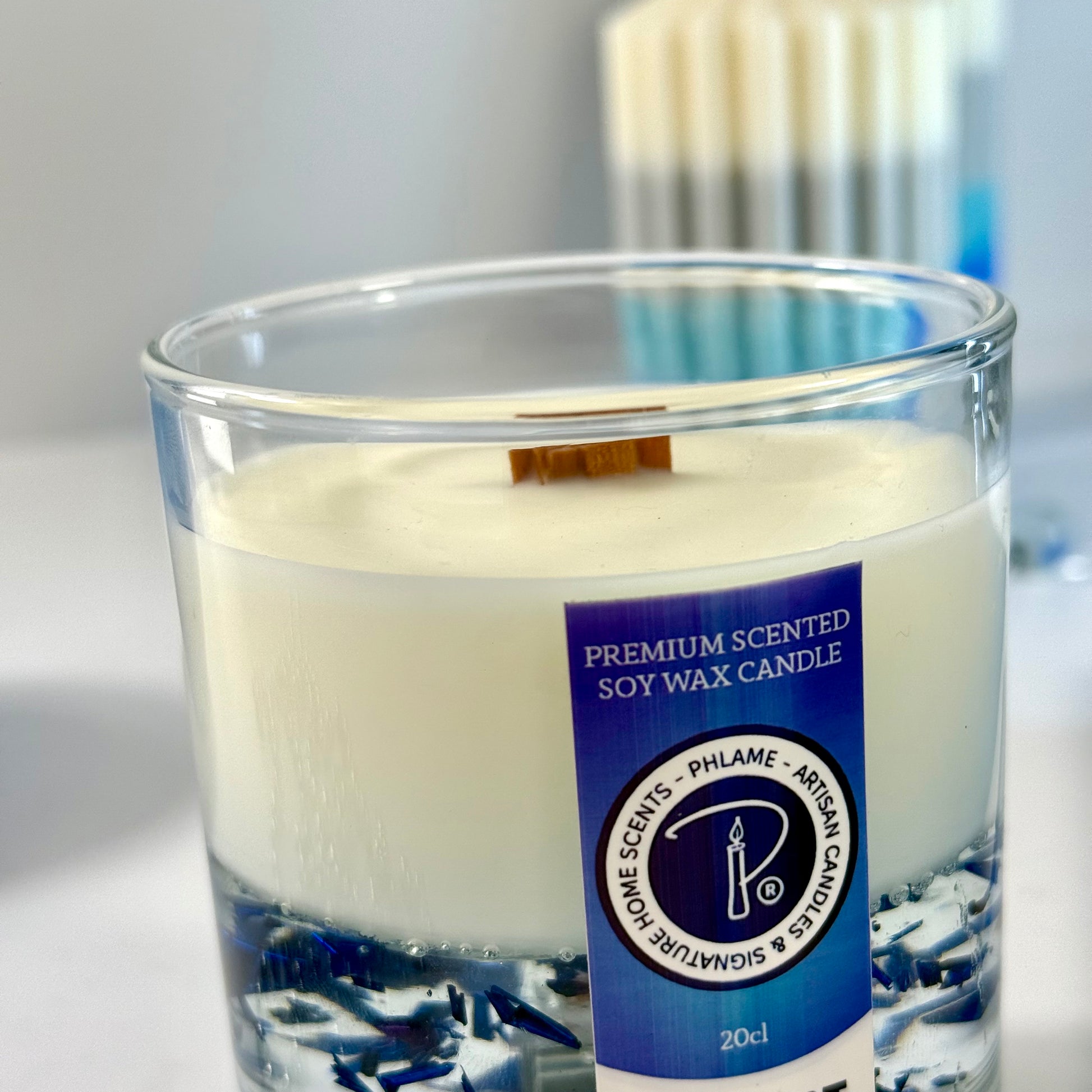 Radiant Savage candle with blue wax detail and black gift box, styled with cool-toned décor.