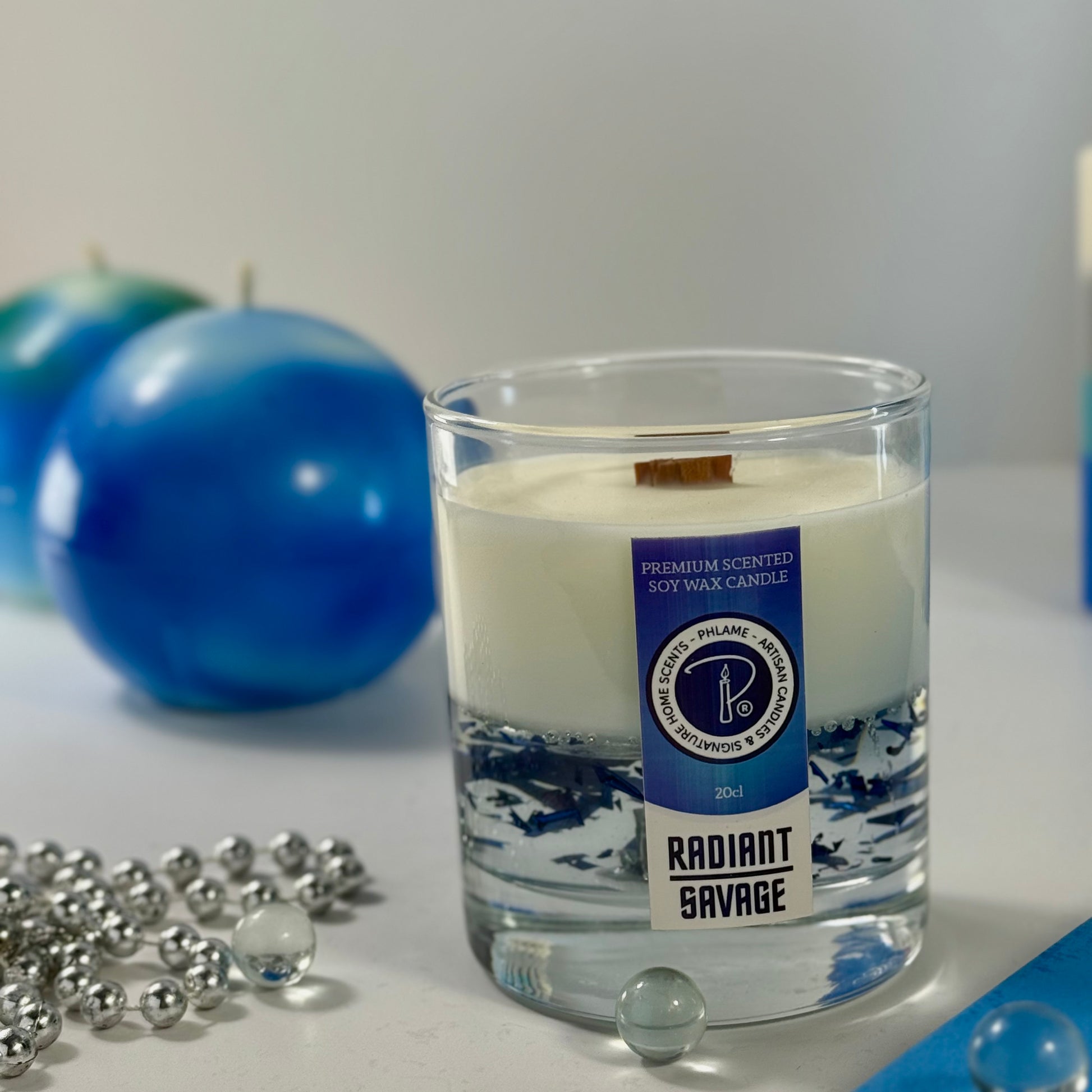 Radiant Savage candle with blue wax detail and black gift box, styled with cool-toned décor.