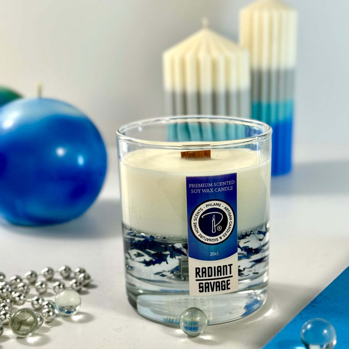 Radiant Savage candle with blue wax detail and black gift box, styled with cool-toned décor.