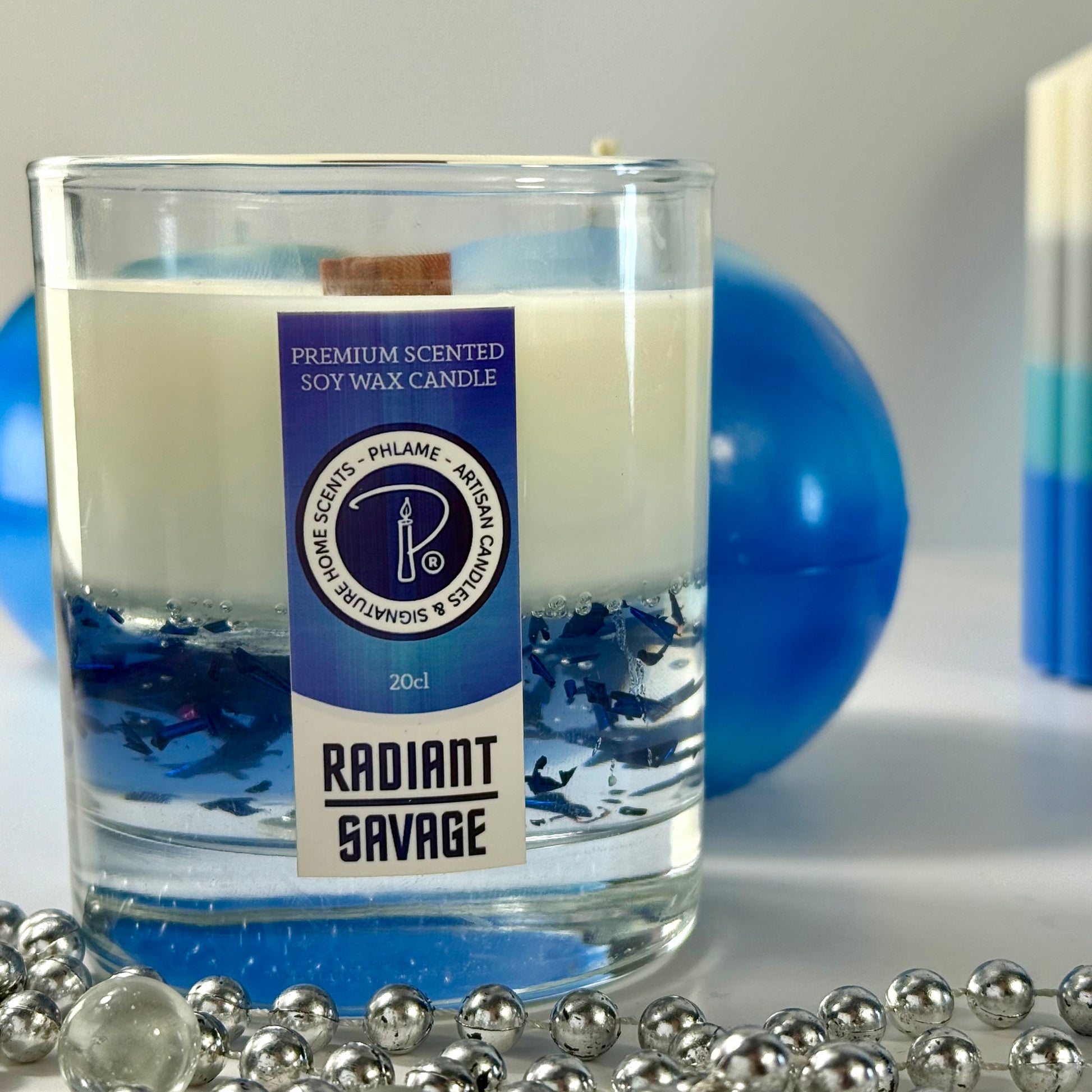Radiant Savage candle with blue wax detail and black gift box, styled with cool-toned décor.