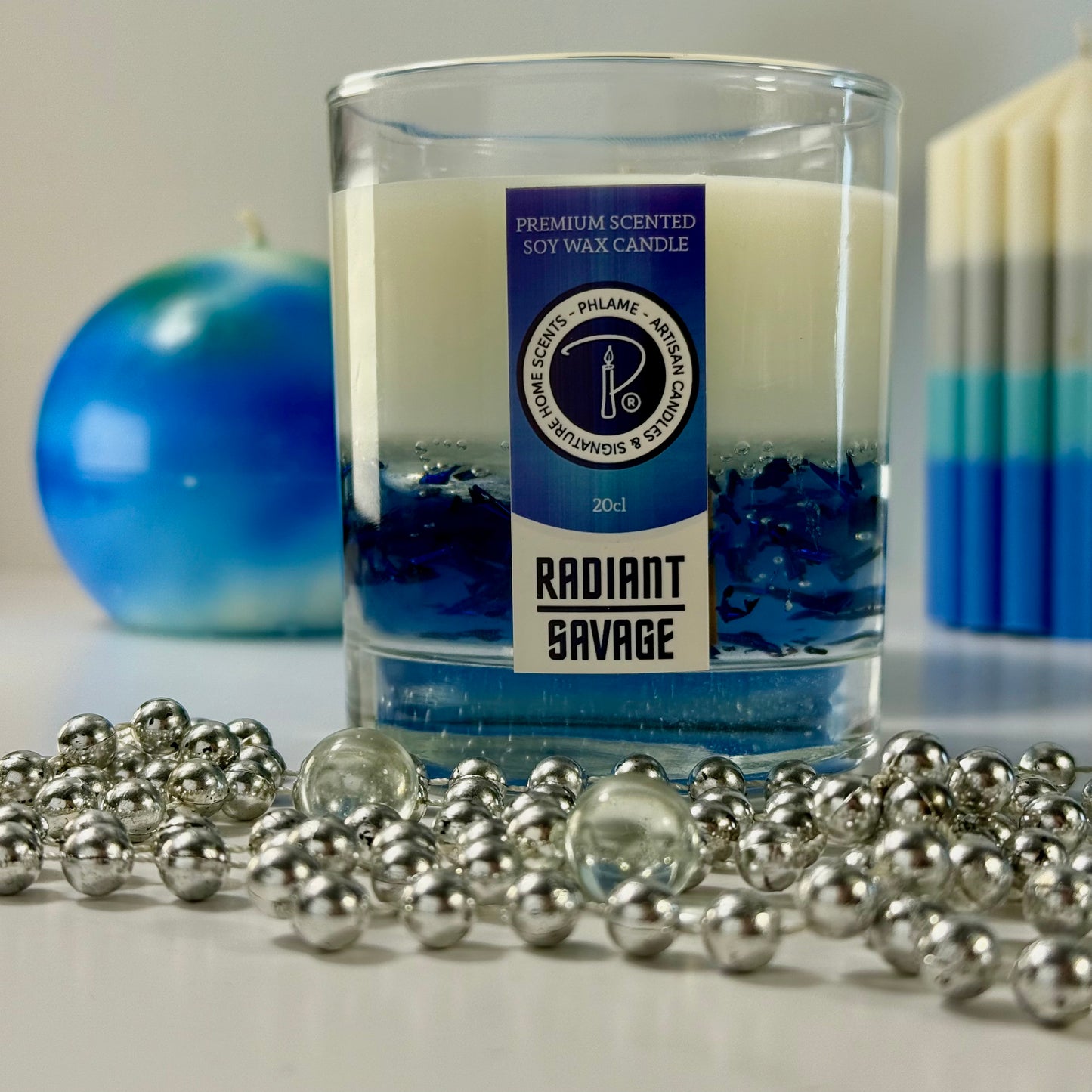 Radiant Savage candle with blue wax detail and black gift box, styled with cool-toned décor.