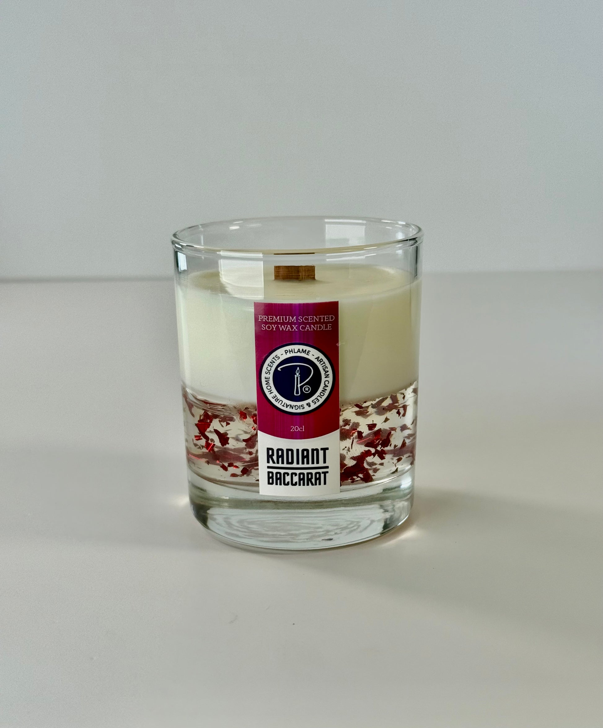 Radiant Baccarat candle with red gel wax and elegant black box, styled for luxury.