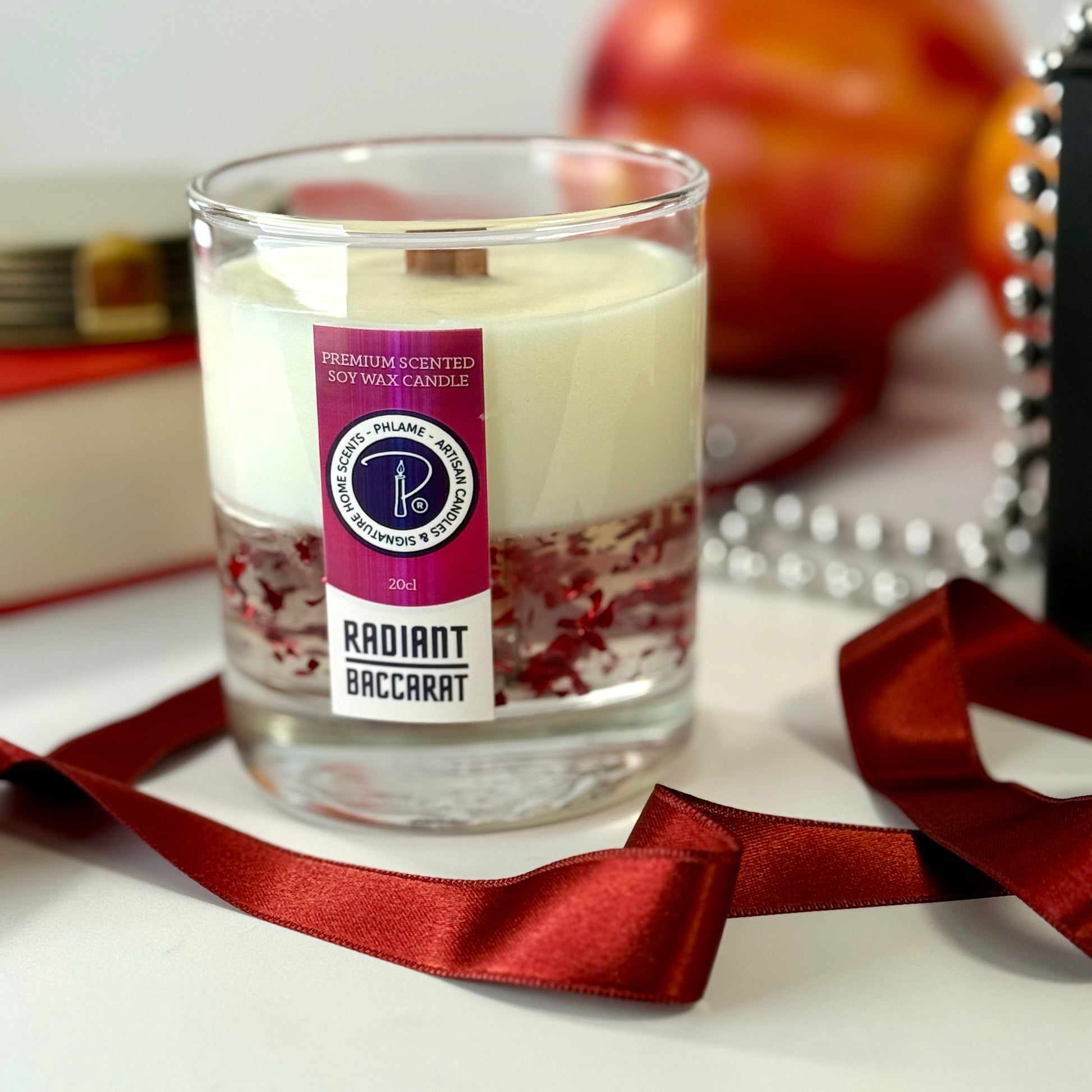 Radiant Baccarat candle with red gel wax and elegant black box, styled for luxury.