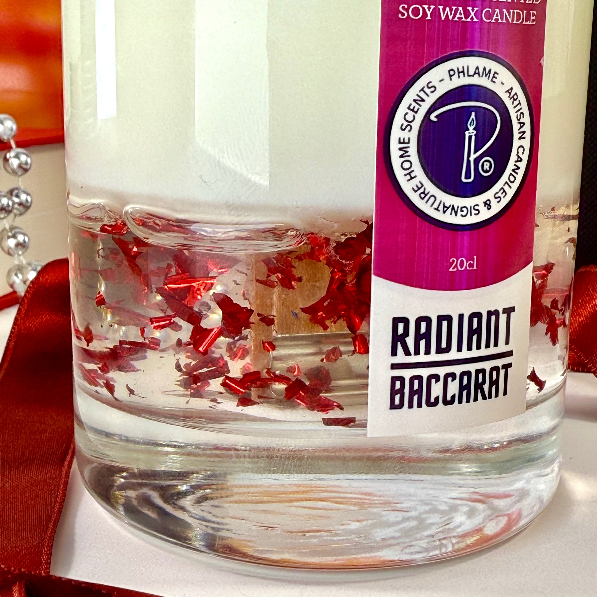 Radiant Baccarat candle with red gel wax and elegant black box, styled for luxury.