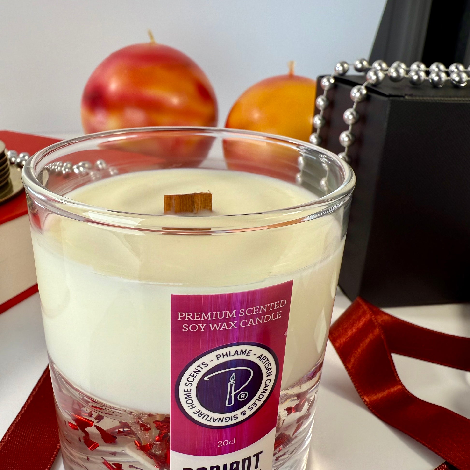 Radiant Baccarat candle with red gel wax and elegant black box, styled for luxury.