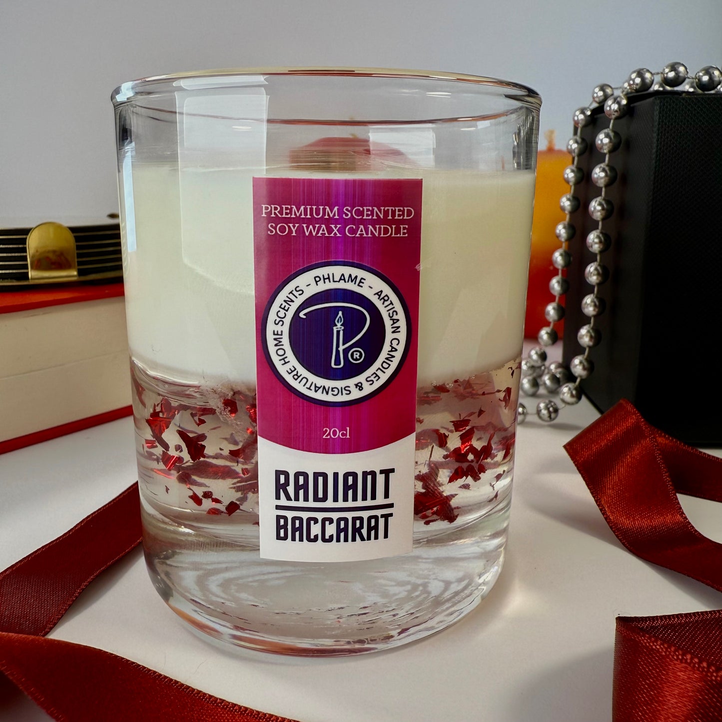 Radiant Baccarat candle with red gel wax and elegant black box, styled for luxury.