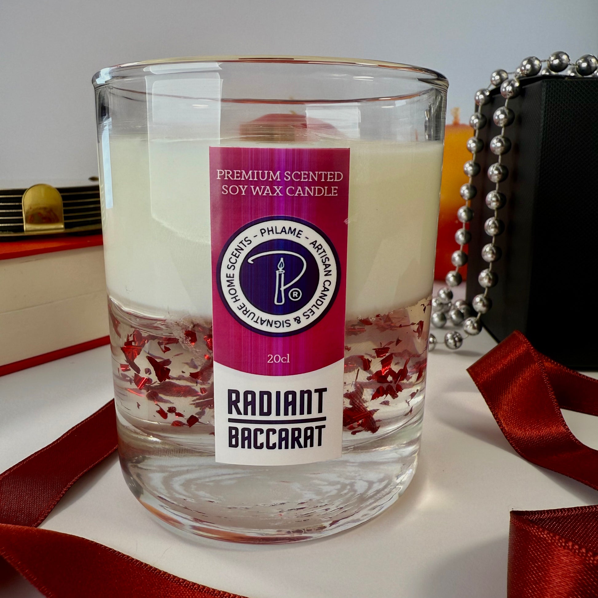 Radiant Baccarat candle with red gel wax and elegant black box, styled for luxury.