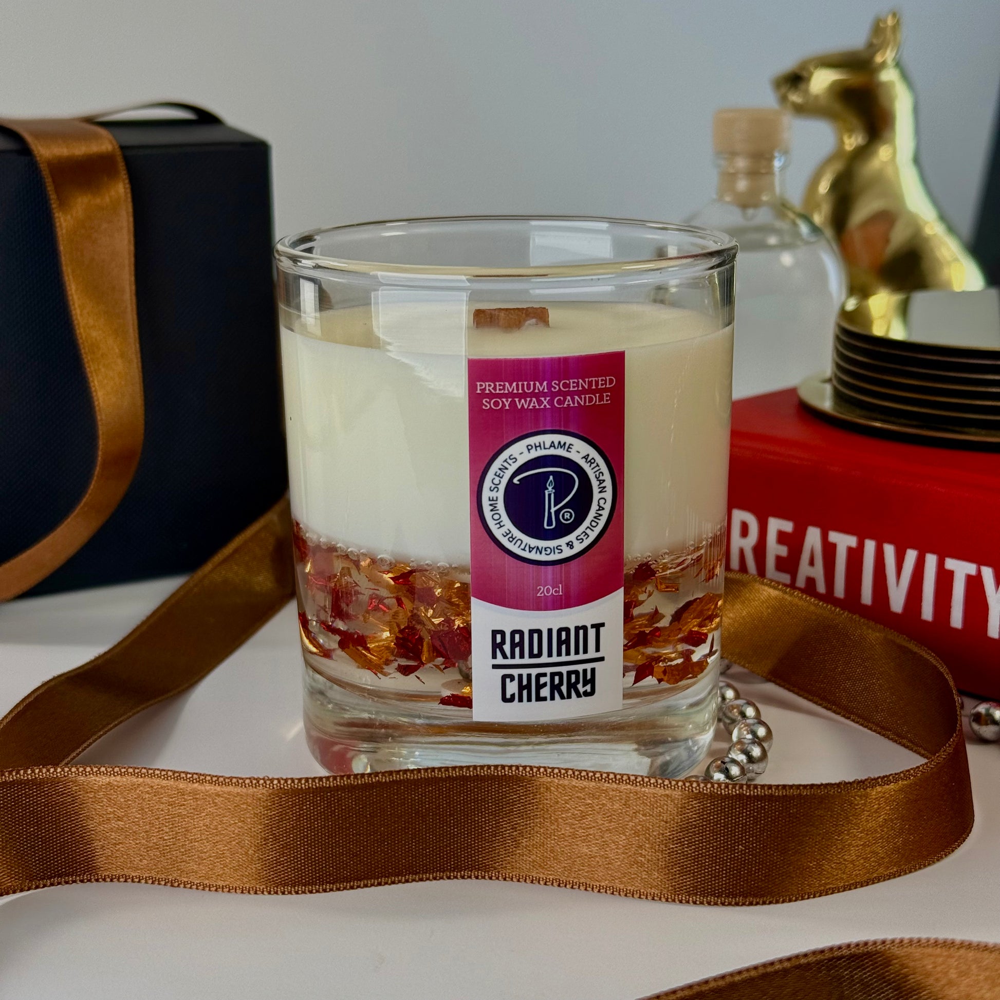 Radiant Cherry candle with shimmering red wax and gift-ready presentation.