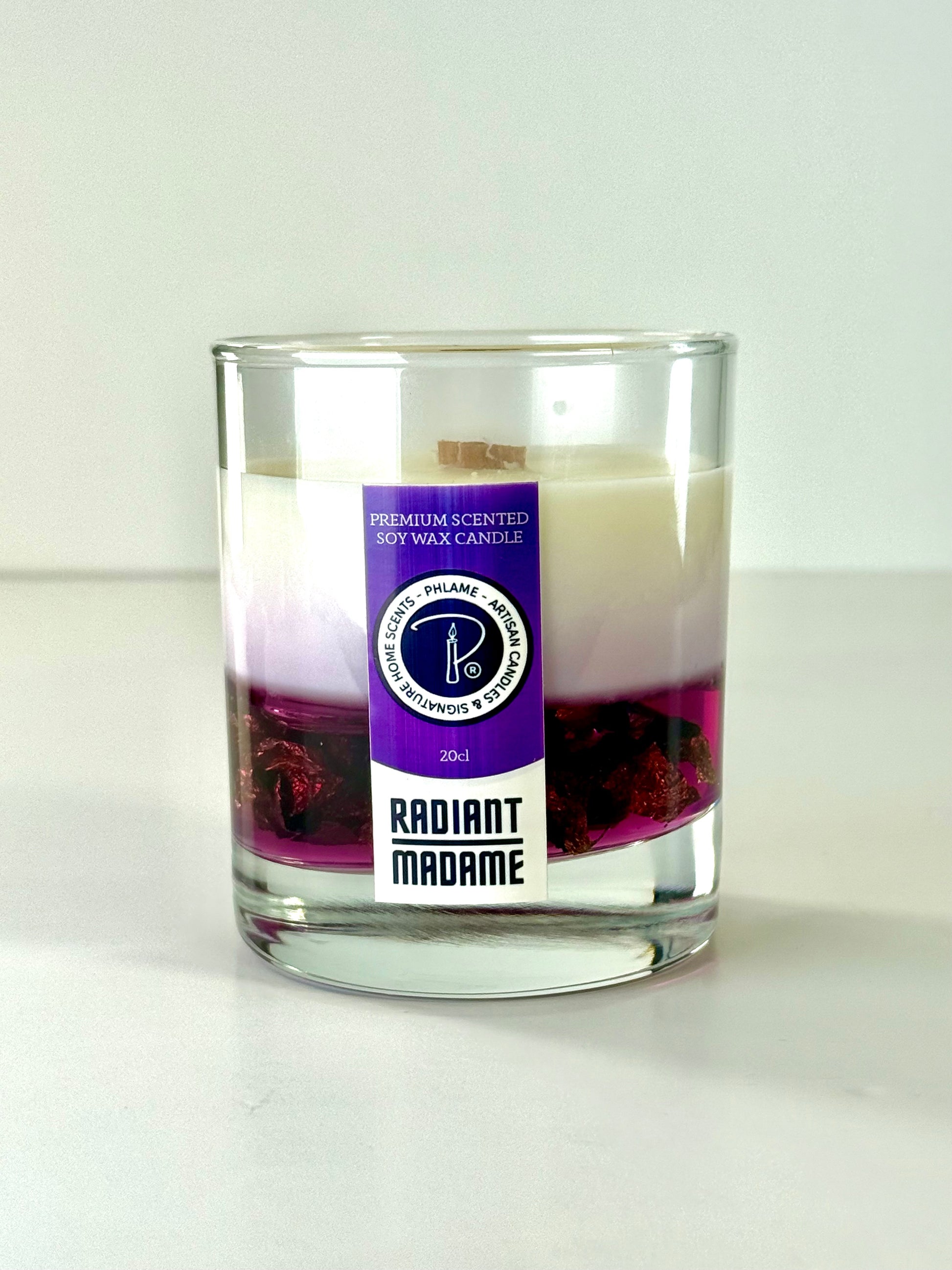 Radiant Madame candle with purple wax and black gift box, styled with feminine décor.