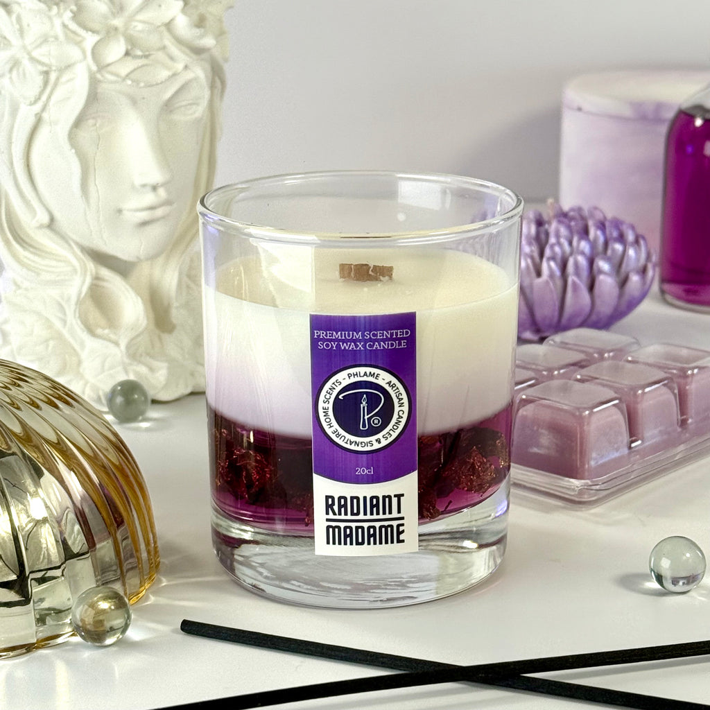 Candle with a 'Radiant Madame' label on a decorative surface