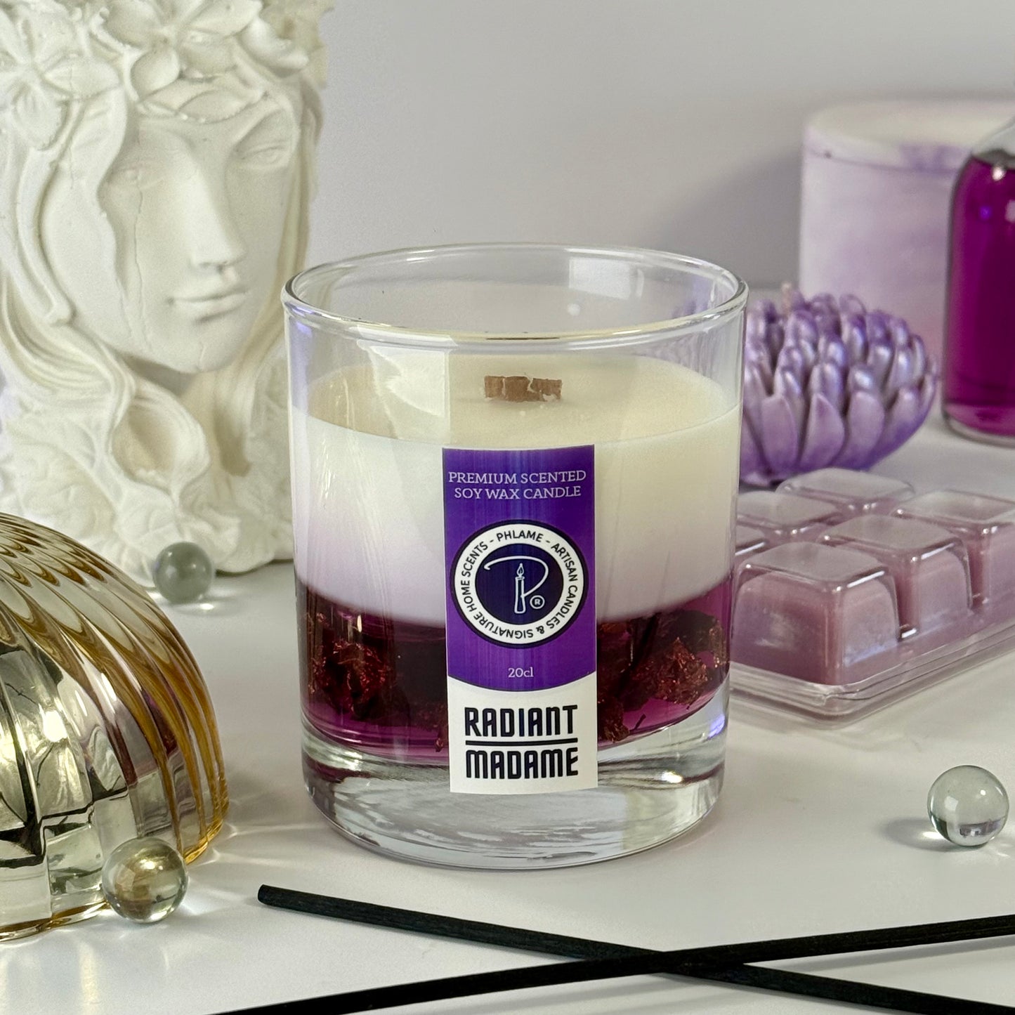Radiant Madame candle with purple wax and black gift box, styled with feminine décor.