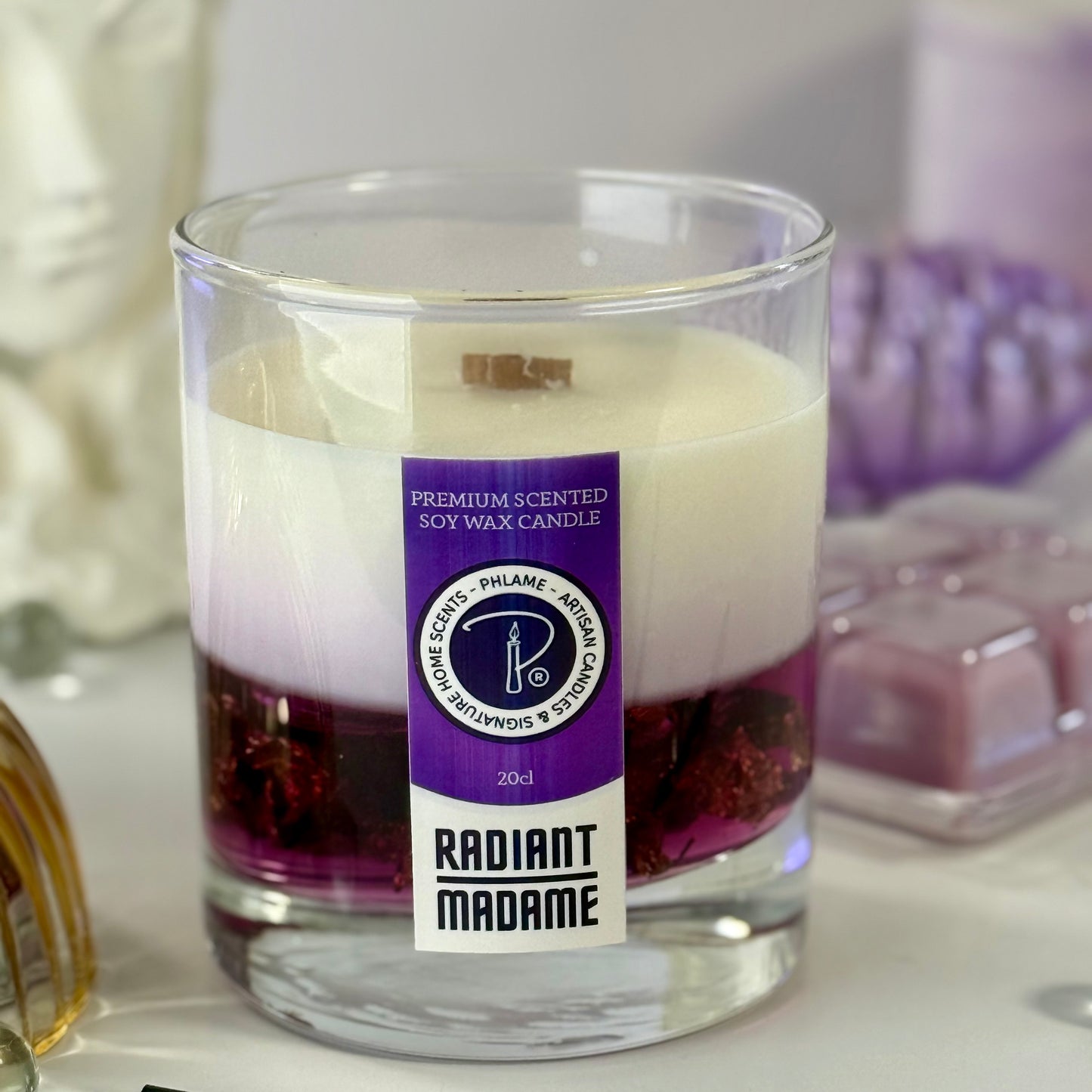 Radiant Madame candle with purple wax and black gift box, styled with feminine décor.