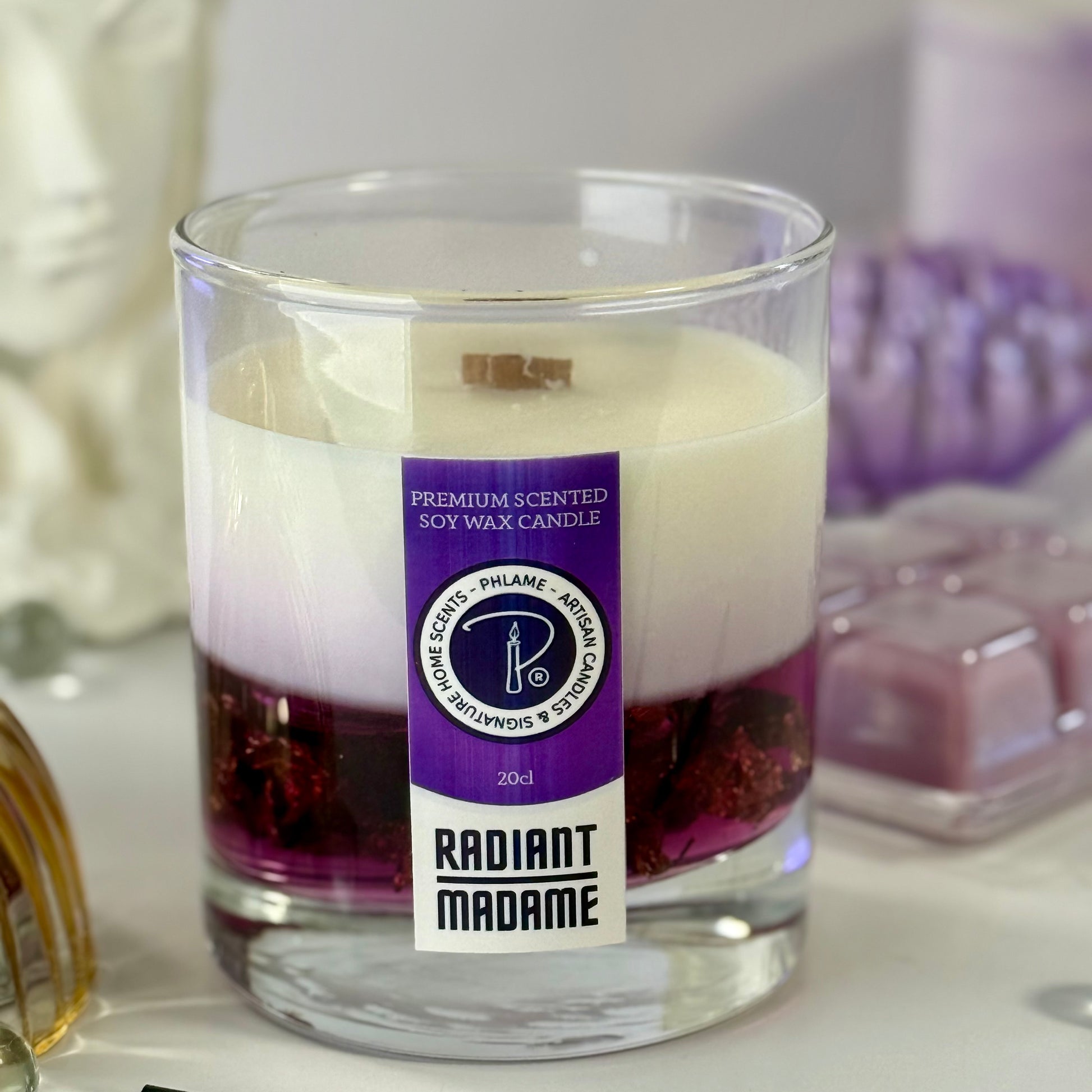 Radiant Madame candle with purple wax and black gift box, styled with feminine décor.