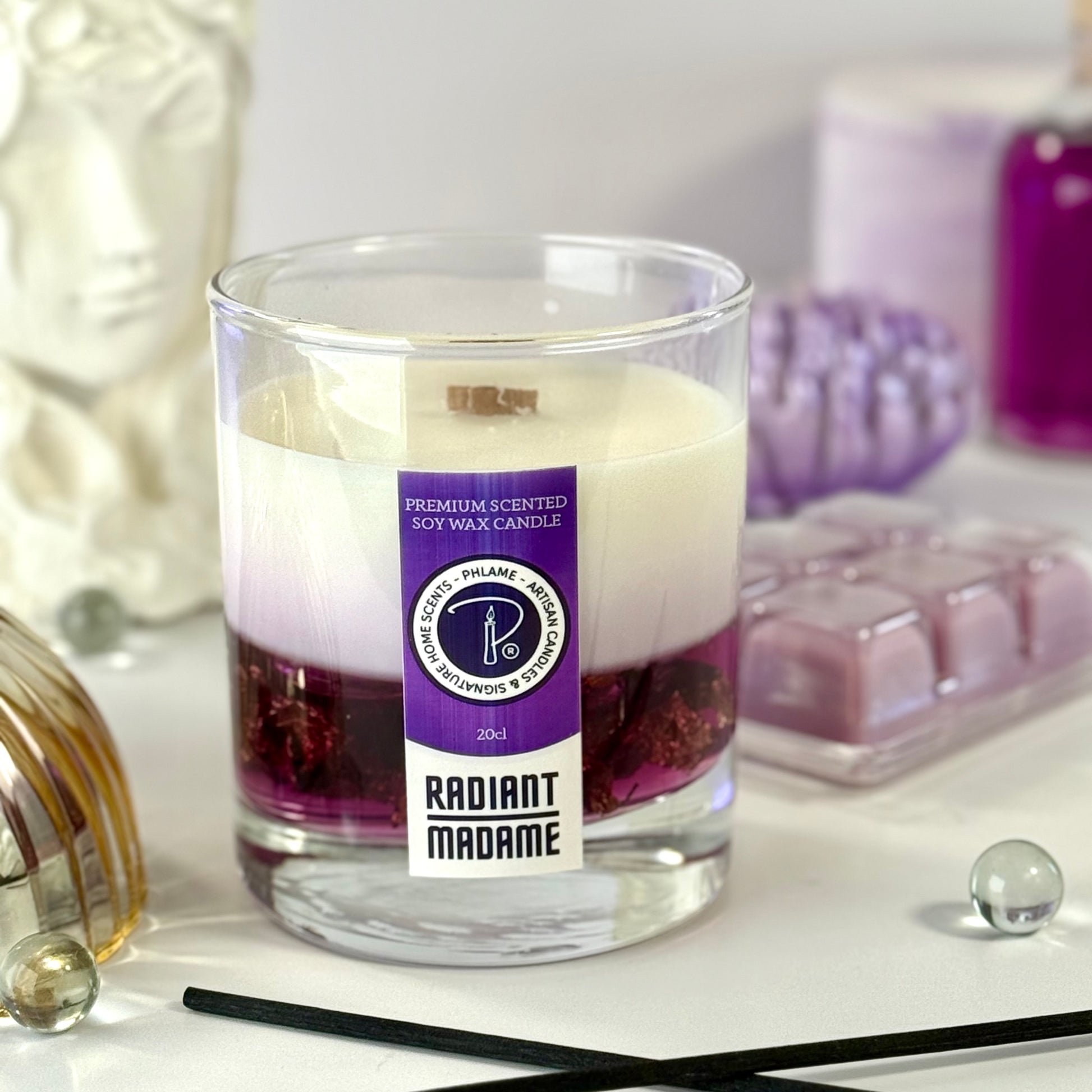 Radiant Madame candle with purple wax and black gift box, styled with feminine décor