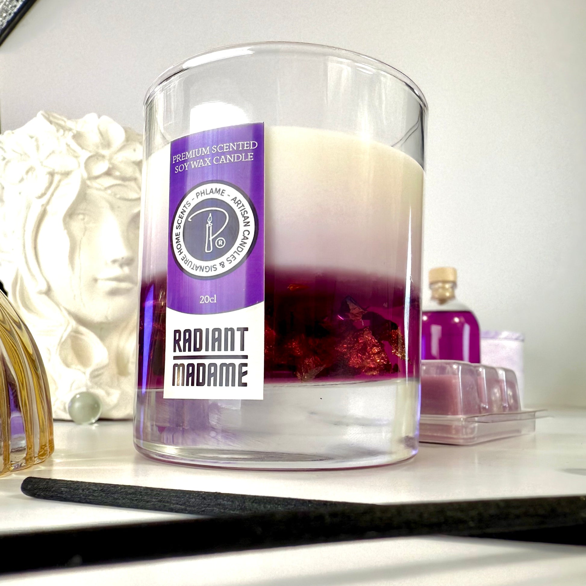 Radiant Madame candle with purple wax and black gift box, styled with feminine décor.