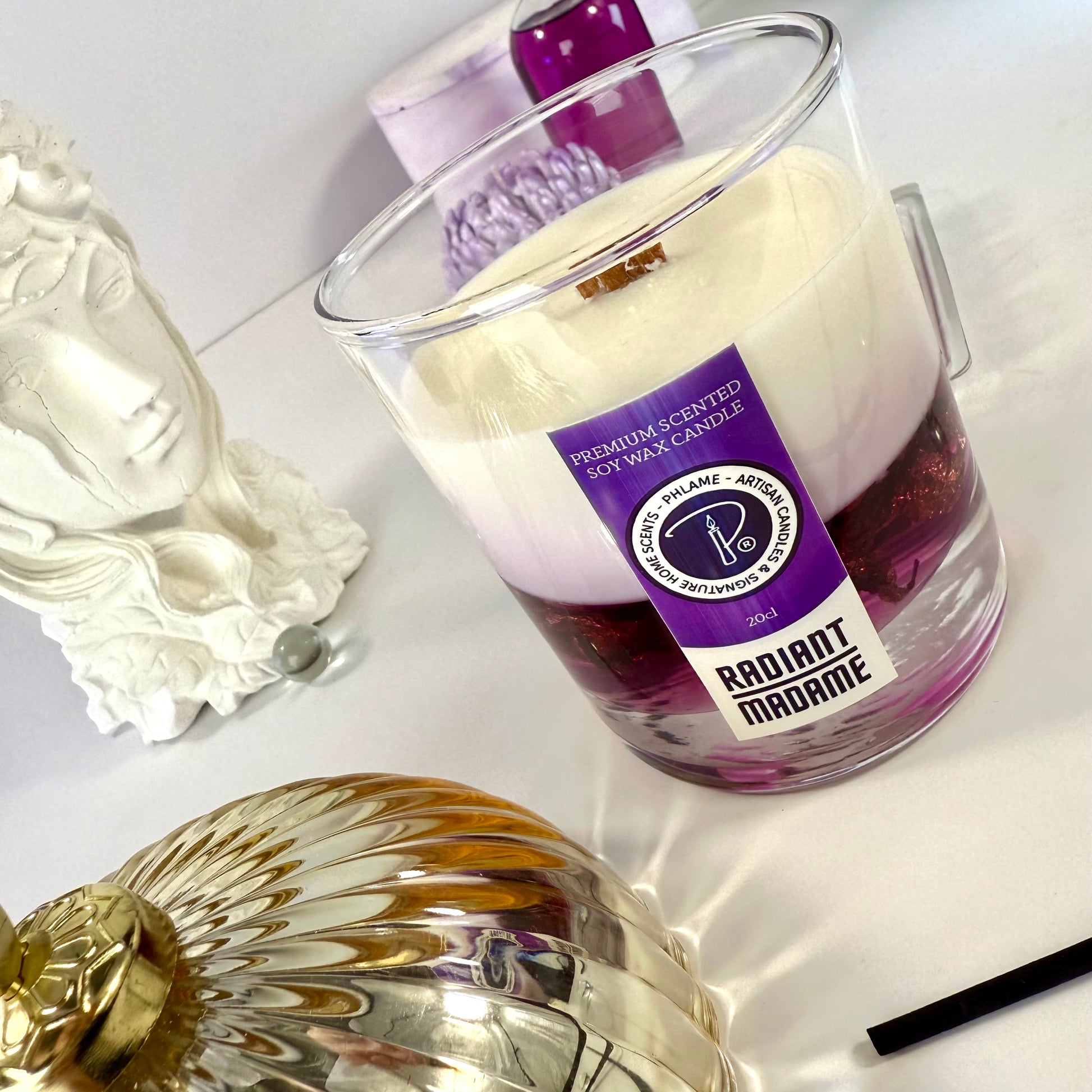 Radiant Madame candle with purple wax and black gift box, styled with feminine décor.
