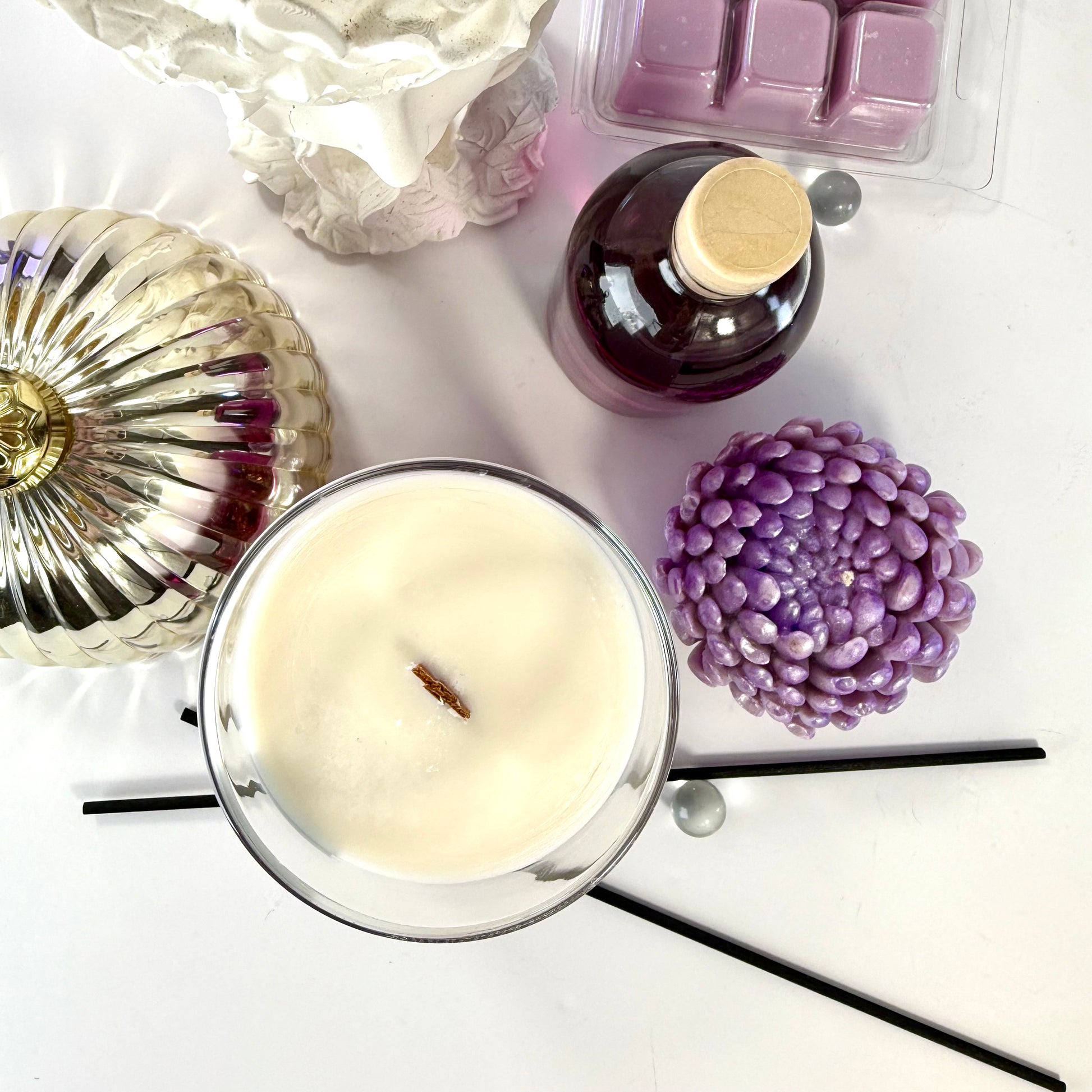 Radiant Madame candle with purple wax and black gift box, styled with feminine décor.