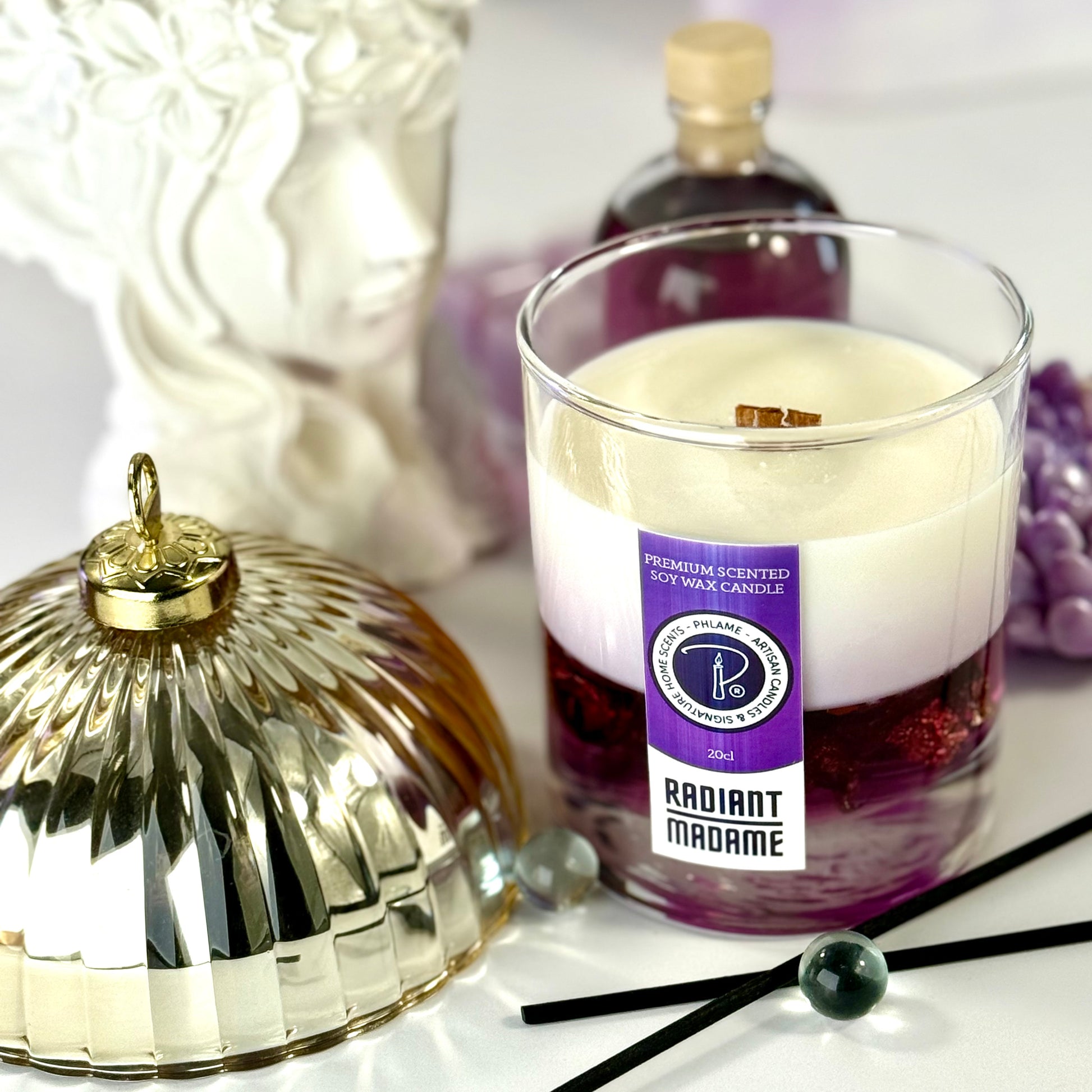 Radiant Madame candle with purple wax and black gift box, styled with feminine décor.