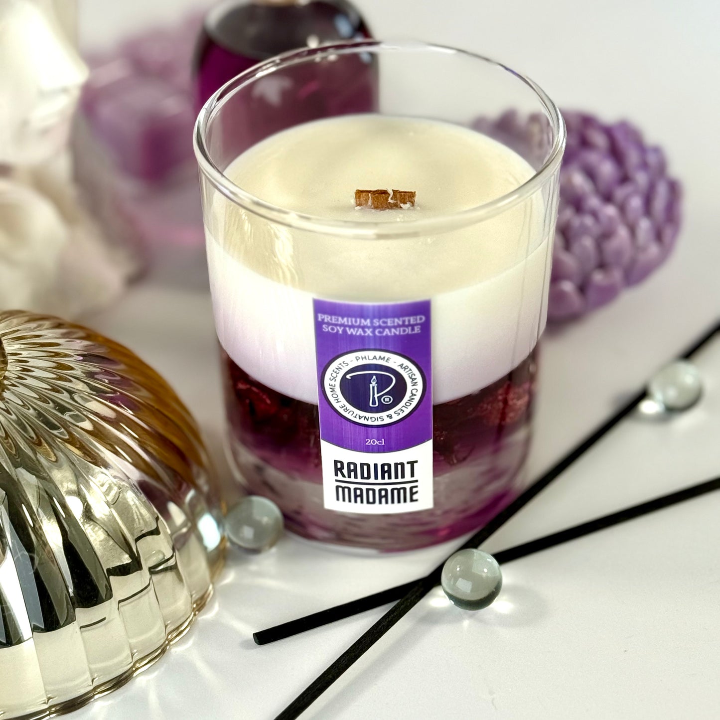Radiant Madame candle with purple wax and black gift box, styled with feminine décor.