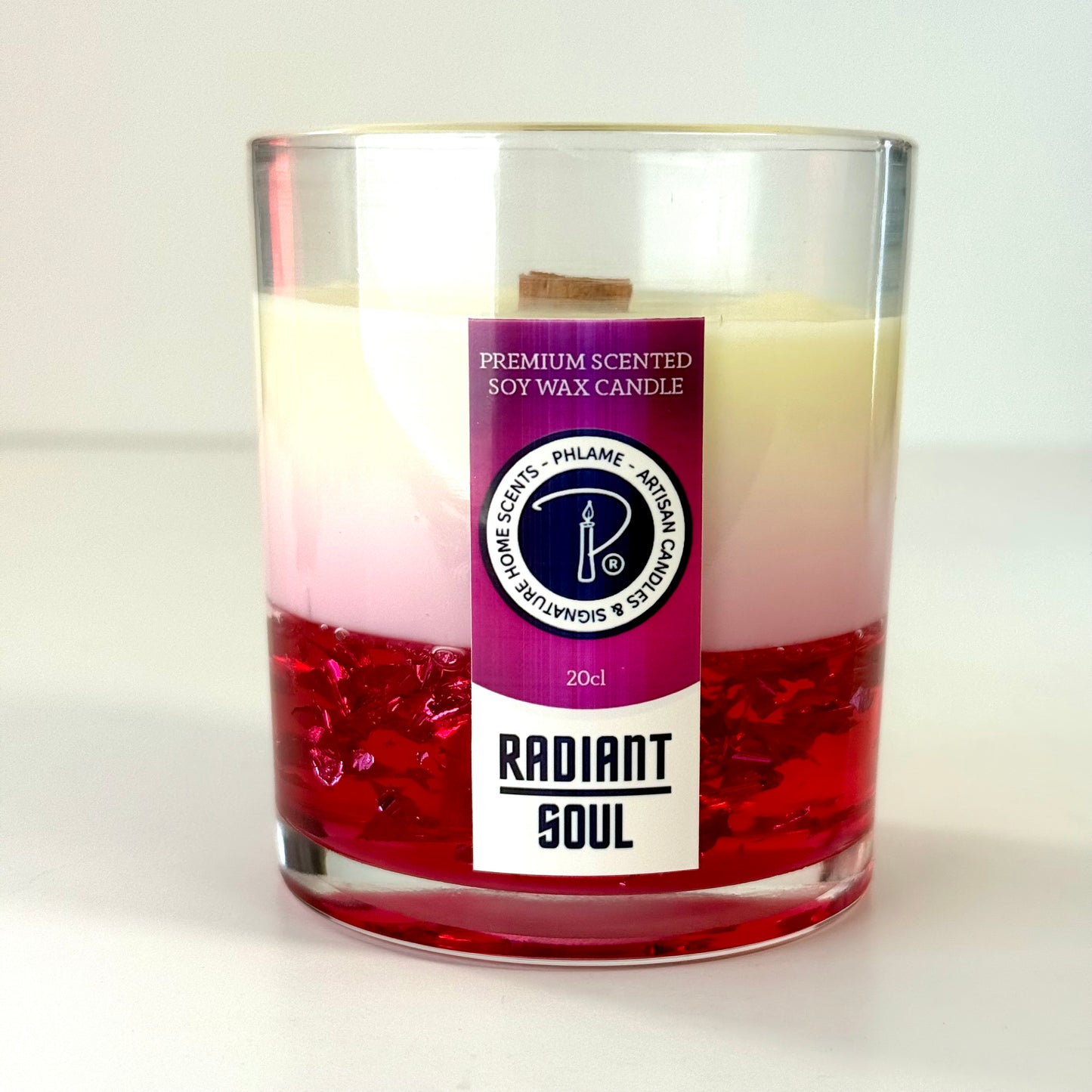 Radiant Soul candle with red gel wax and wooden wick, displayed in gift setting.