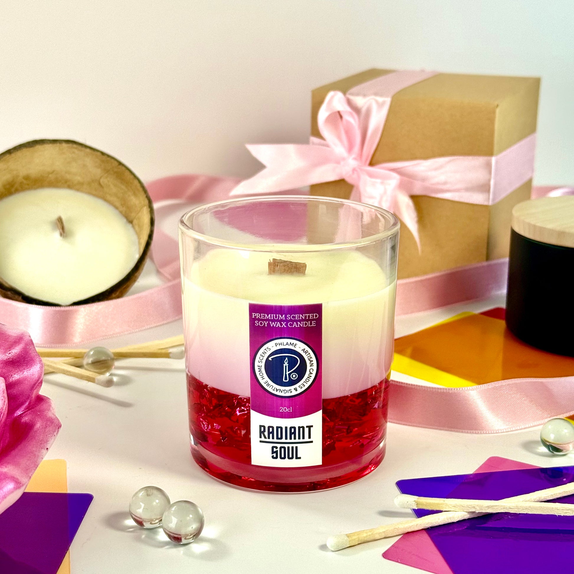 Radiant Soul candle with red gel wax and wooden wick, displayed in gift setting.