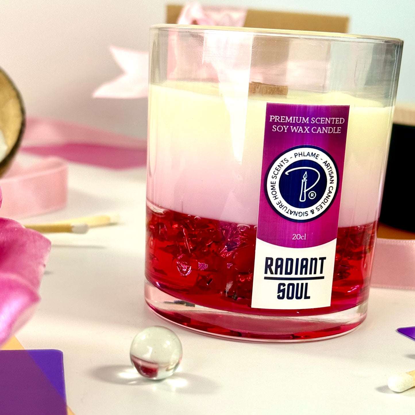 Radiant Soul candle with red gel wax and wooden wick, displayed in gift setting.