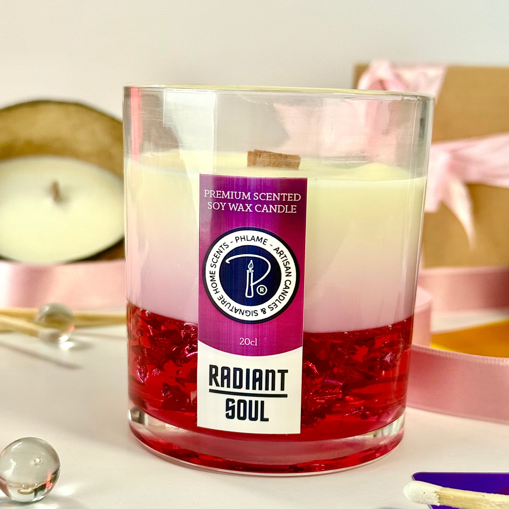 Radiant Soul candle with red gel wax and wooden wick, displayed in gift setting.