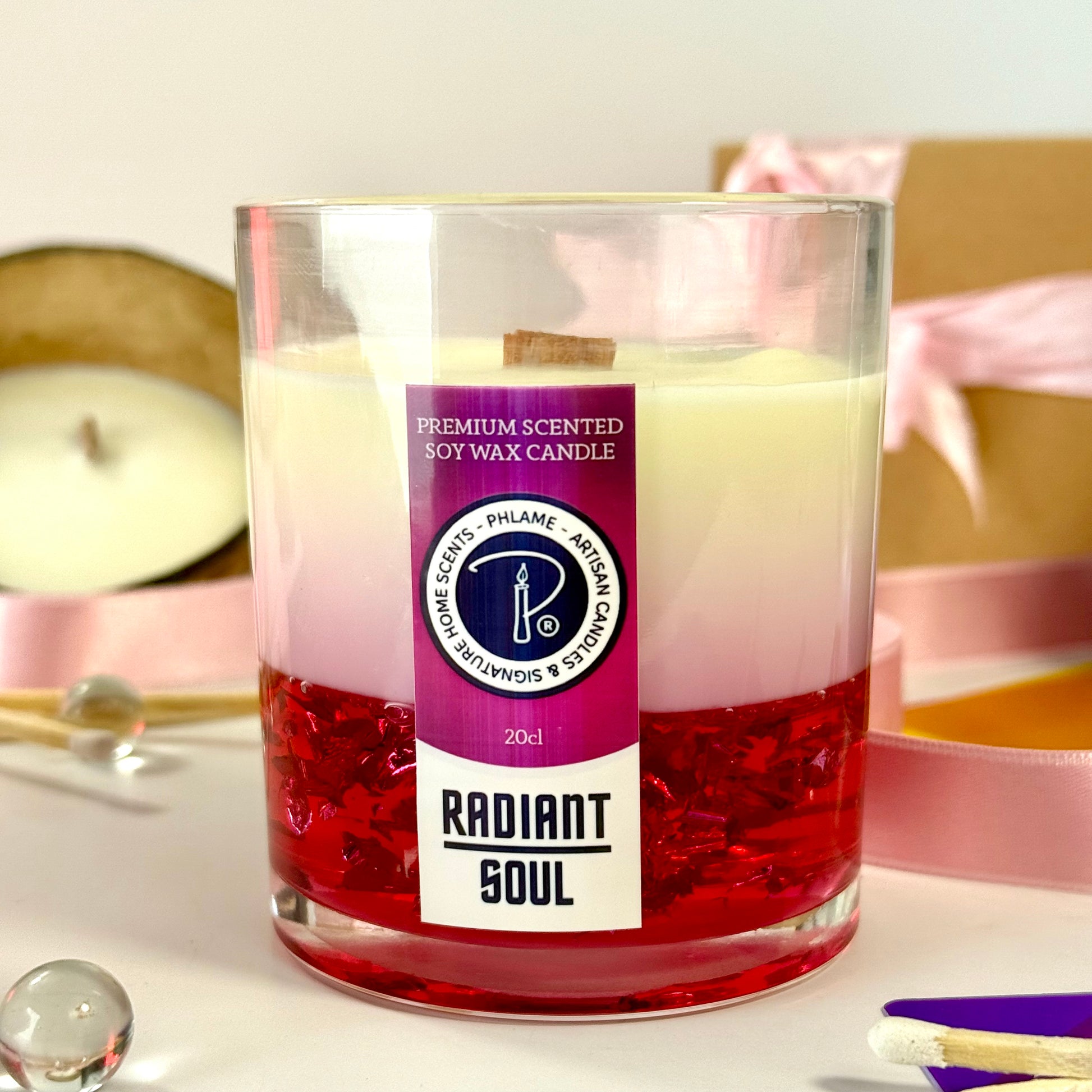 Radiant Soul candle with red gel wax and wooden wick, displayed in gift setting.