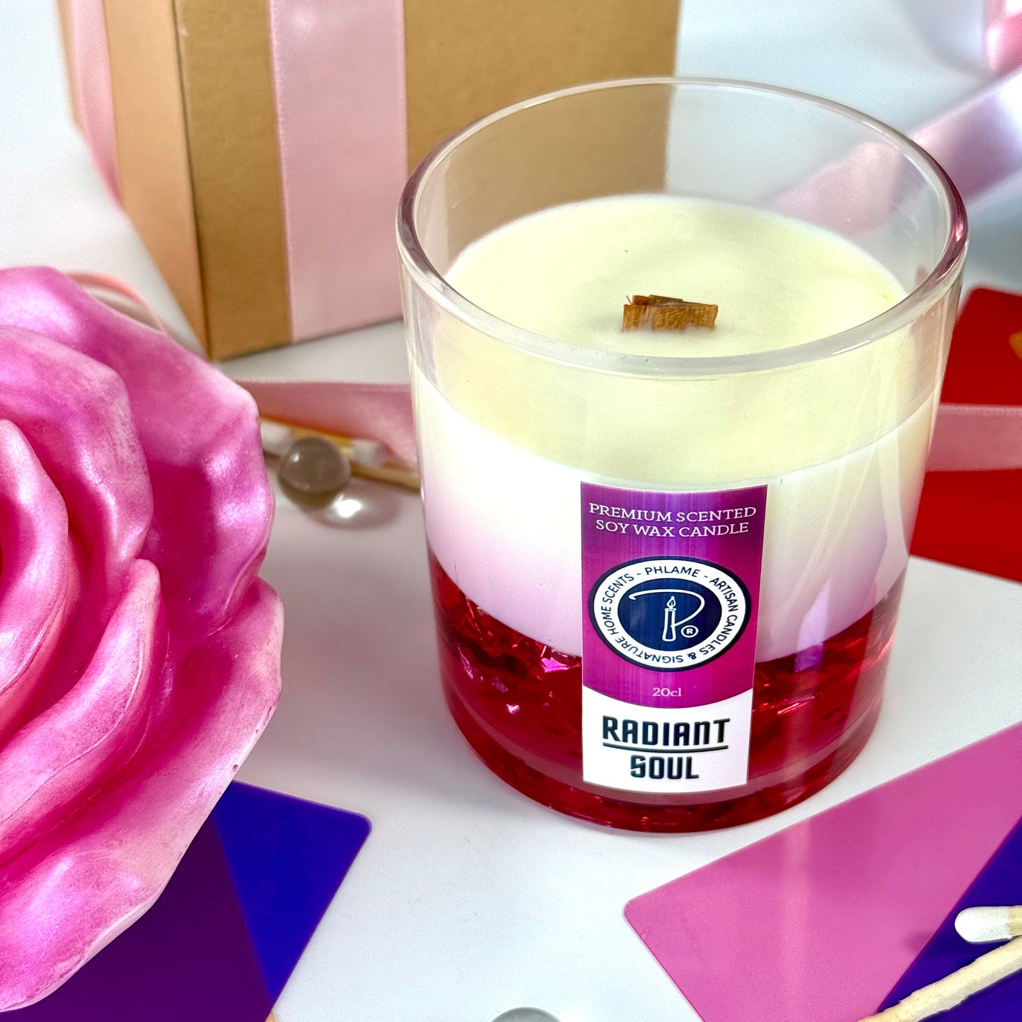 Radiant Soul candle with red gel wax and wooden wick, displayed in gift setting.