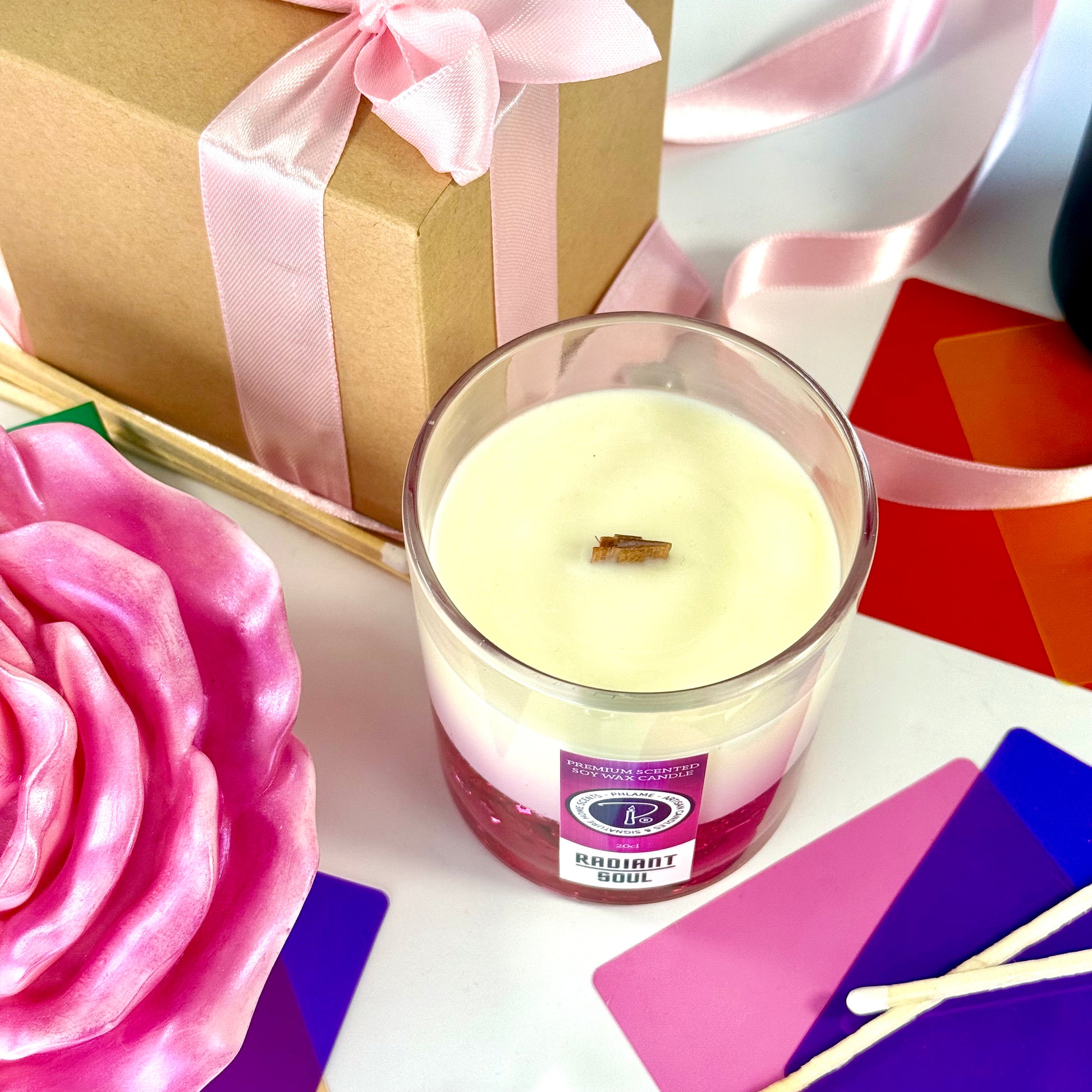 Radiant Soul candle with red gel wax and wooden wick, displayed in gift setting.