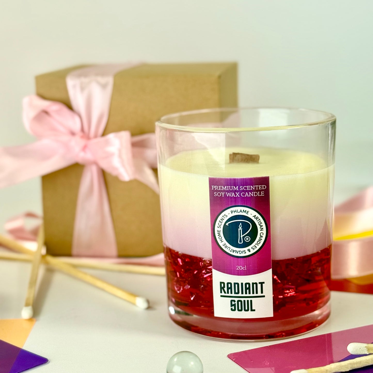 Radiant Soul candle with red gel wax and wooden wick, displayed in gift setting.