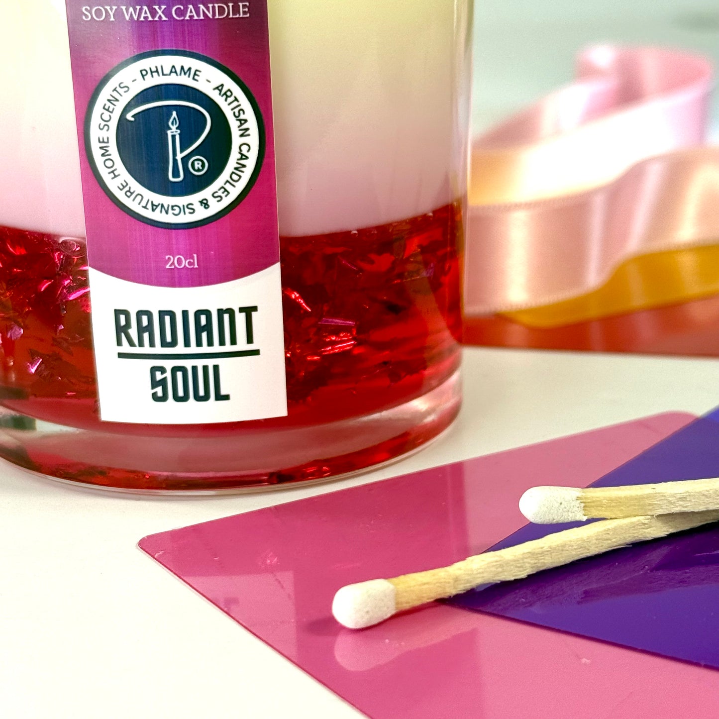 Radiant Soul candle with red gel wax and wooden wick, displayed in gift setting.