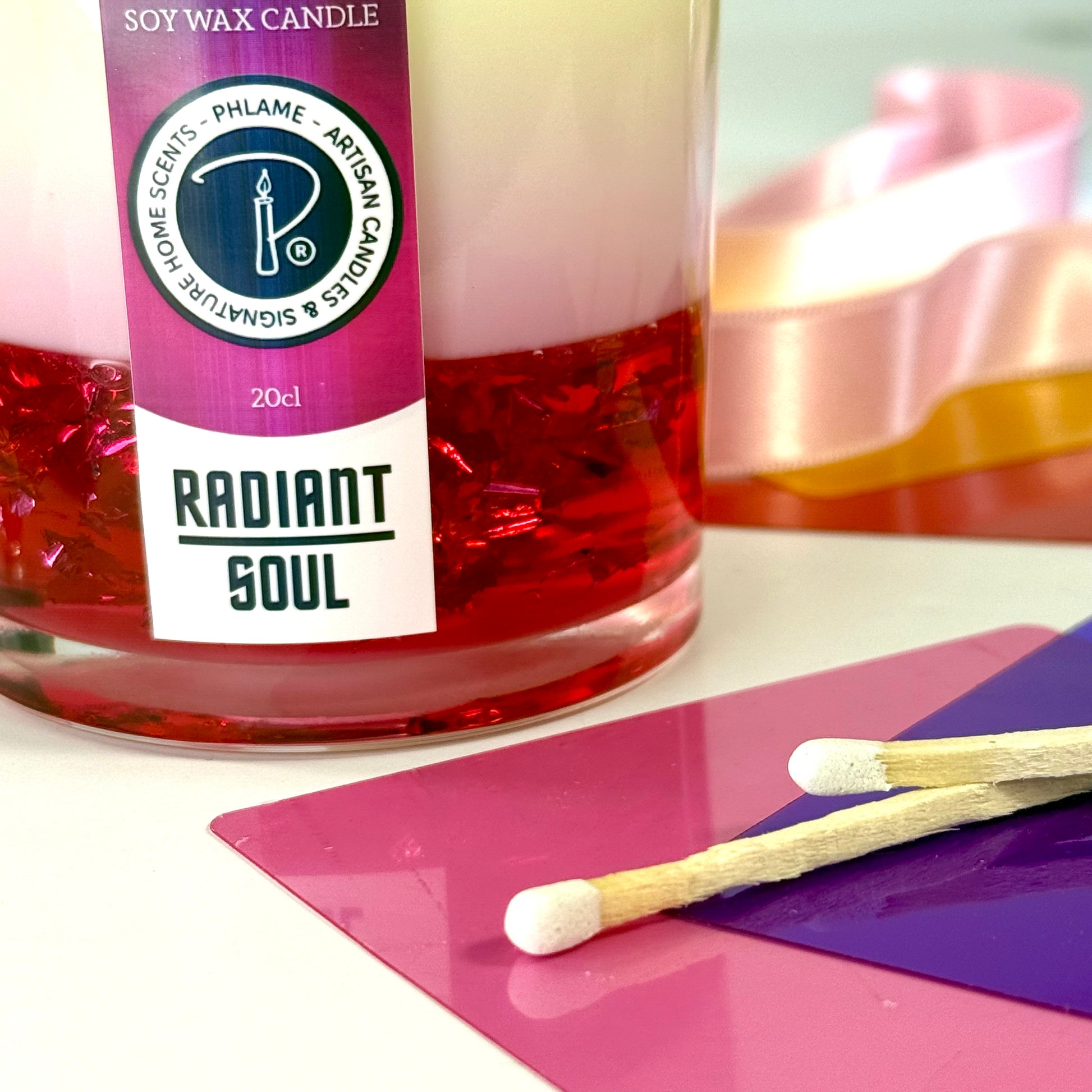 Radiant Soul candle with red gel wax and wooden wick, displayed in gift setting.