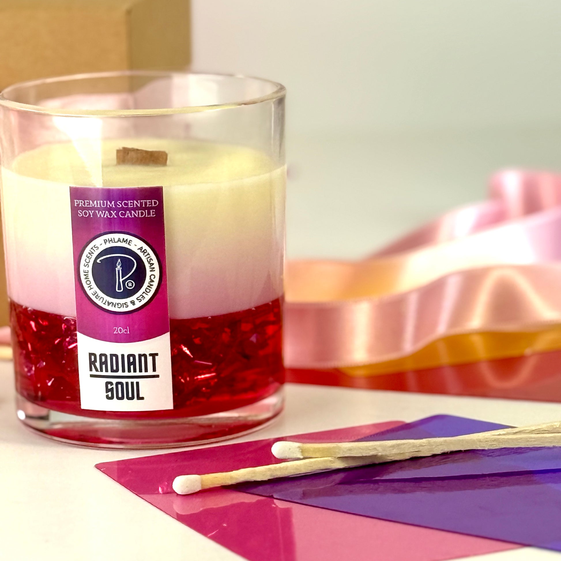 Radiant Soul candle with red gel wax and wooden wick, displayed in gift setting.